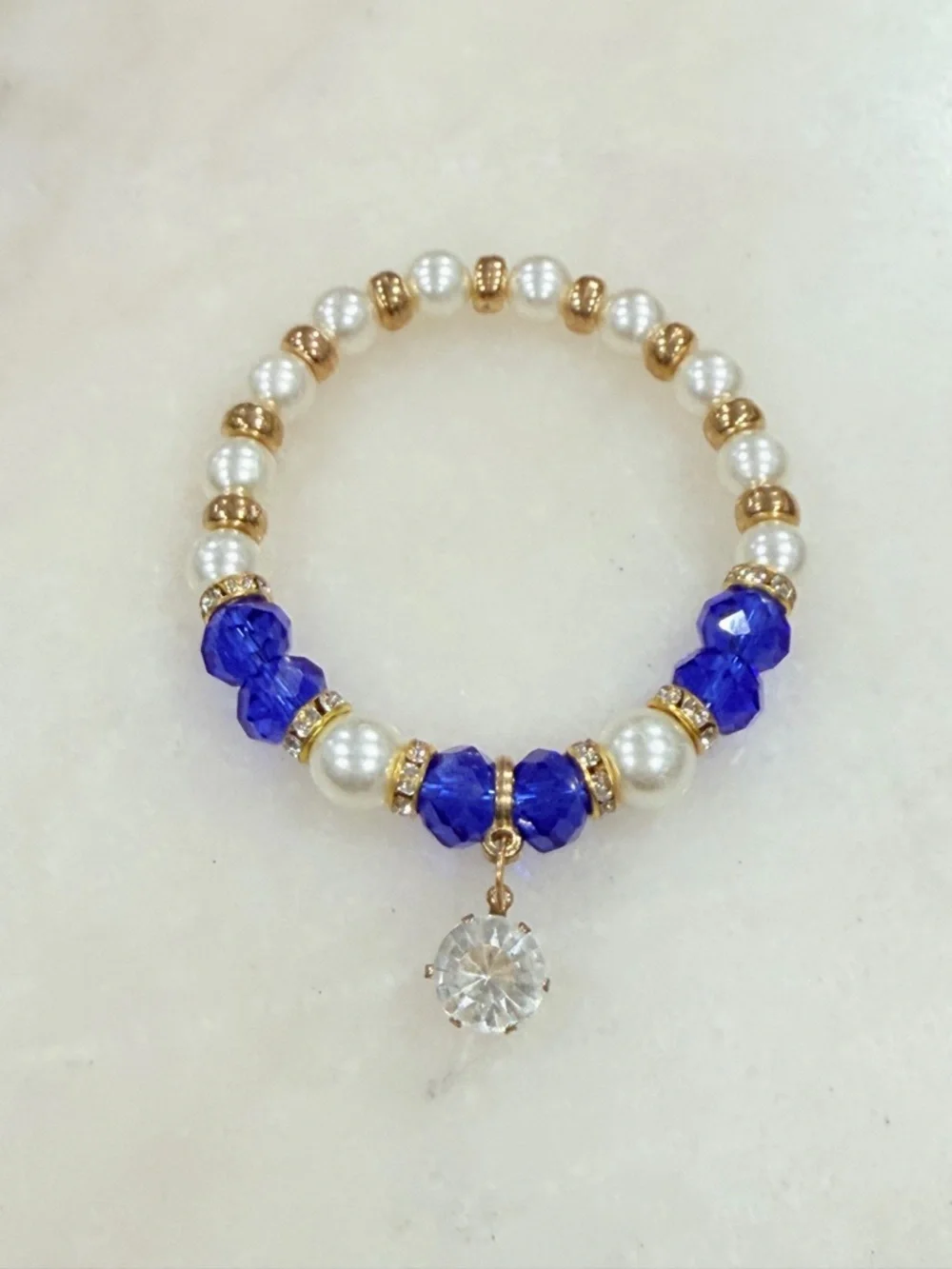 Gold and Pearl Beaded Stretch Bracelet with Blue Crystal Accents and Charm